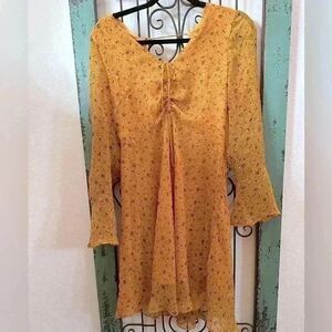 Yellow fitted floral print dress.